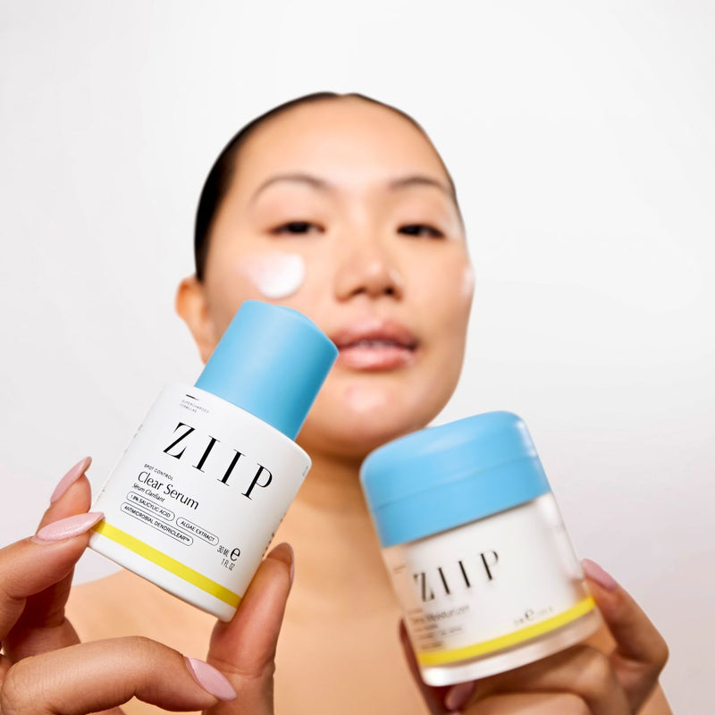 A woman holds the Spot Control Skincare products in her hands.